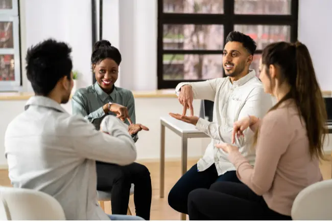 Four people communicating in American Sign Language
