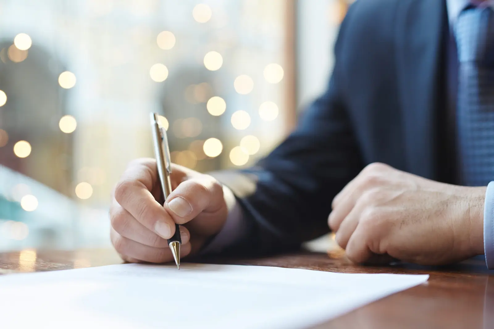 Business professional signing an agreement