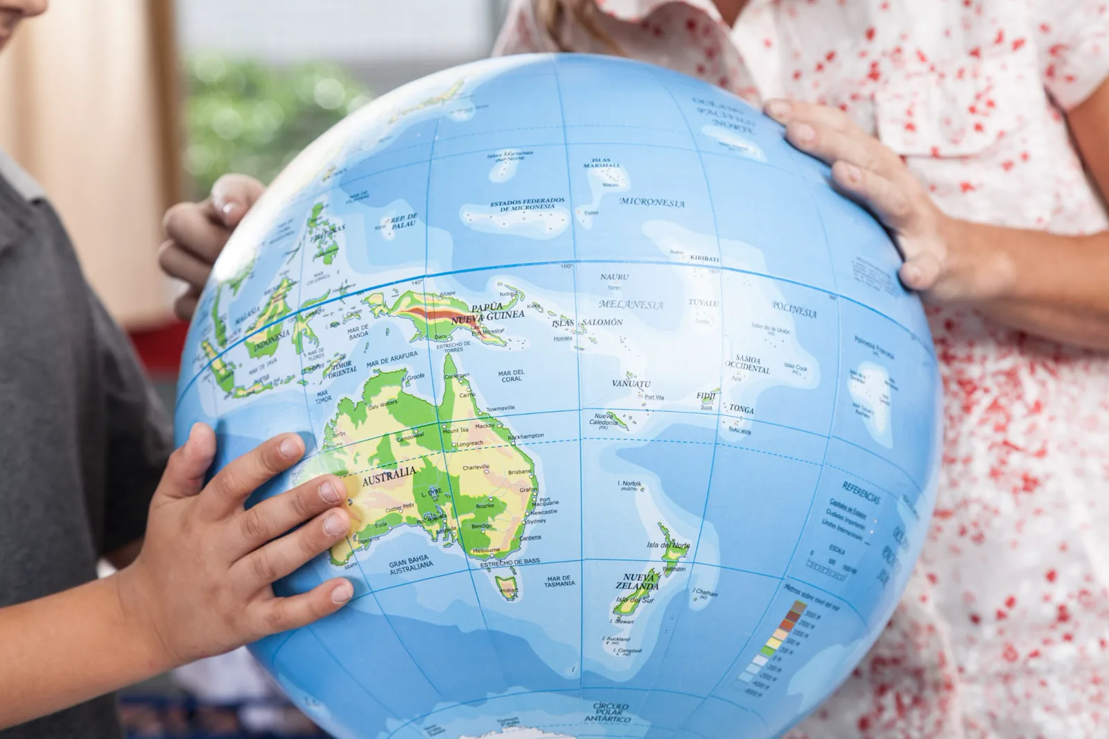 Children exploring a world globe together