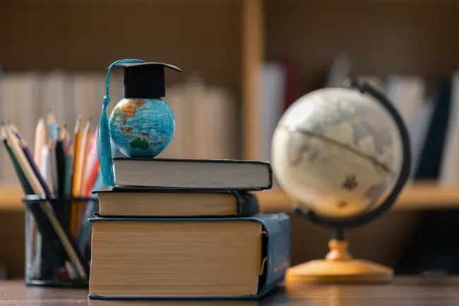 Books, globes, and a graduation cap representing language access education