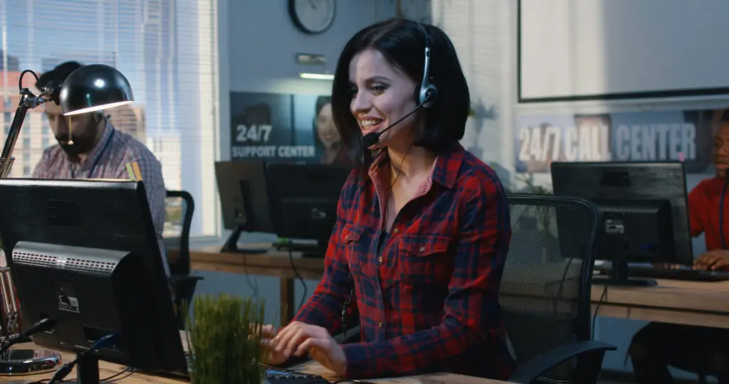 Support specialist wearing a headset at a call center
