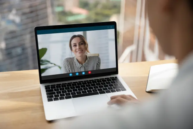 Person participating in a video call on a laptop